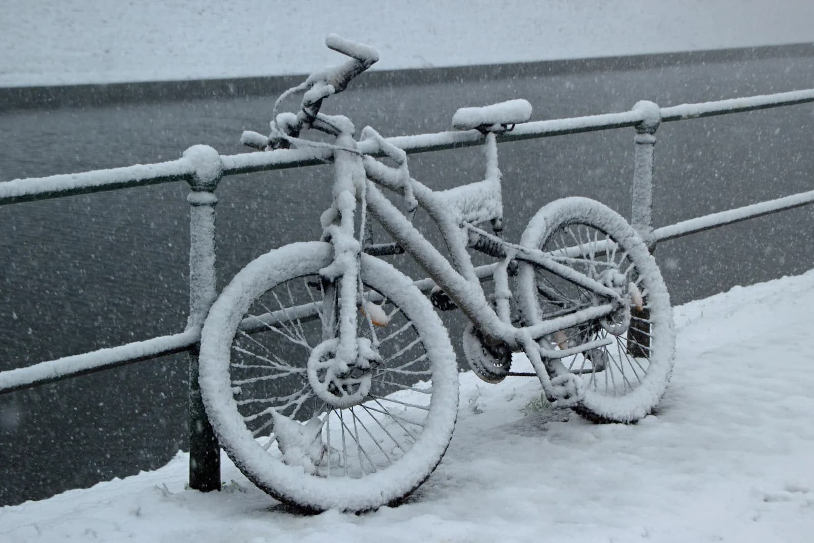 E-Bike Akku im Winter – eingeschneites Fahrrad als Symbol für die Winterpause